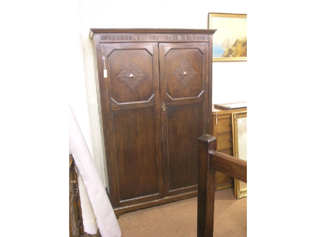 Appraisal: An early th century solid dark oak wardrobe enclosed by