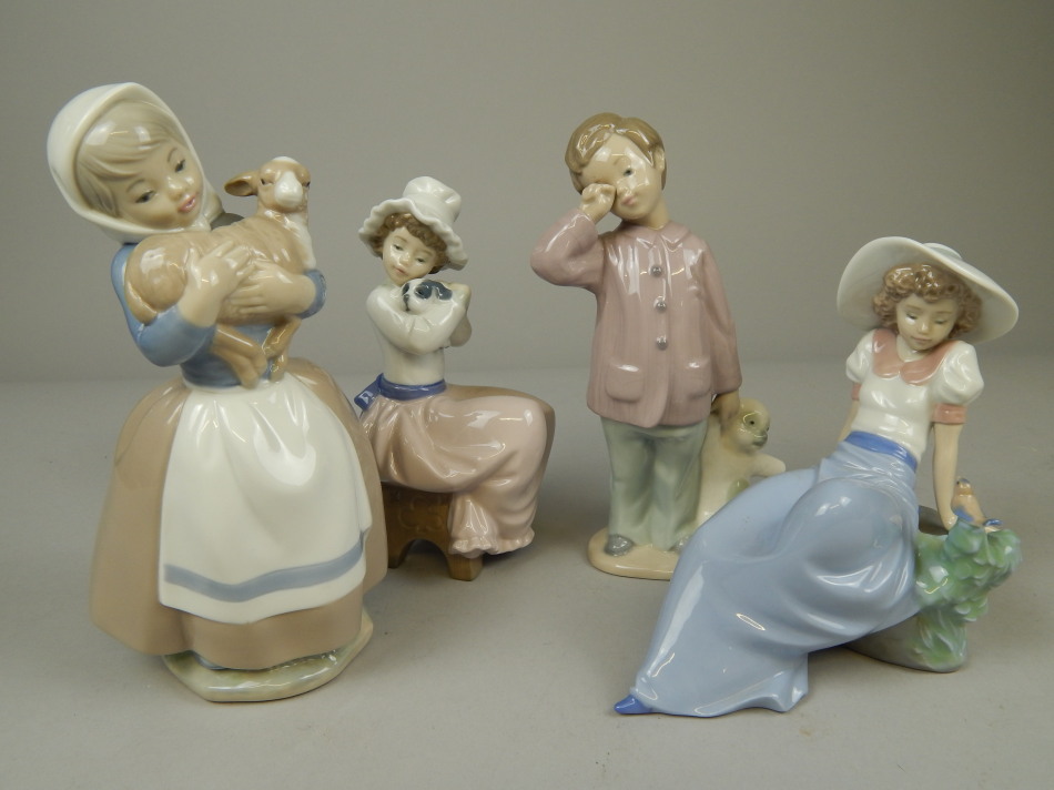 Appraisal: Four Nao Spanish porcelain figures each of children in various