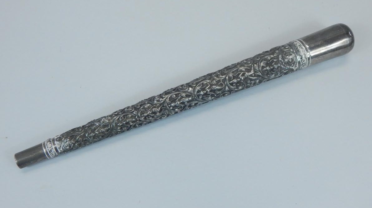 Appraisal: A white metal parasol handle embossed with flowers scrolls etc