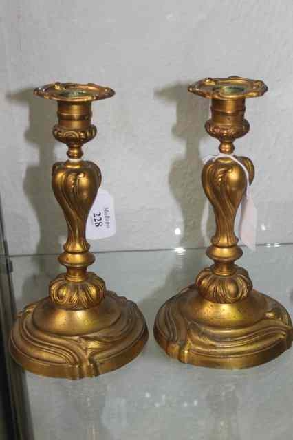 Appraisal: A PAIR OF FRENCH CAST GILT ROCOCO CANDLESTICKS of stylised