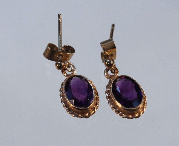 Appraisal: A pair of drop earrings set with amethyst in oval