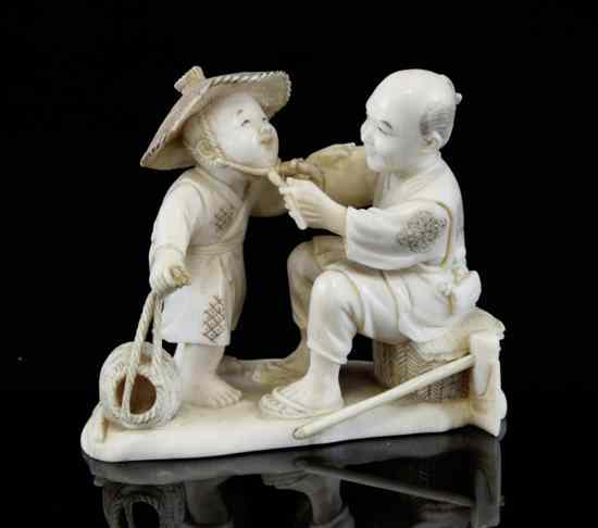 Appraisal: A Japanese ivory group of a woodsman and a boy