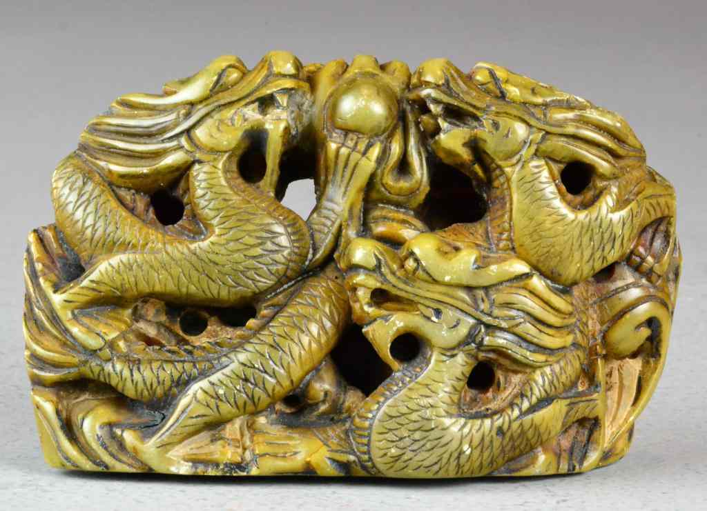 Appraisal: Chinese Soapstone DragonDepicting three carved dragons holding a pearl in