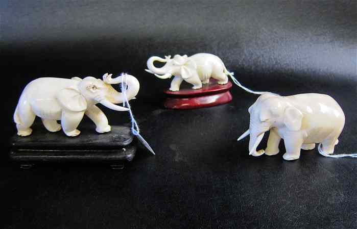 Appraisal: THREE CHINESE IVORY CARVED ELEPHANT two with upturned trunks appearing