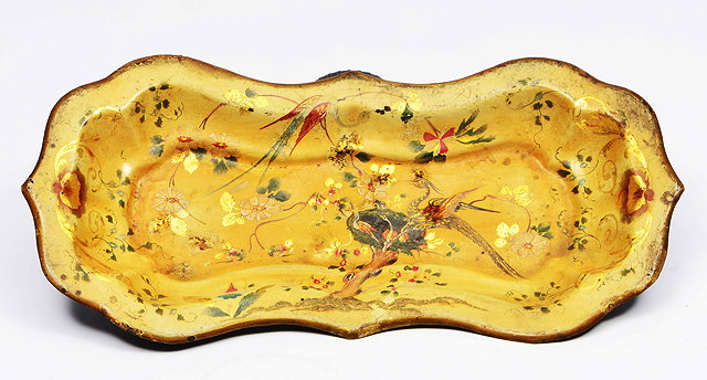 Appraisal: A PONTYPOOL JAPANNED WARE SNUFFER TRAY with shaped edge and