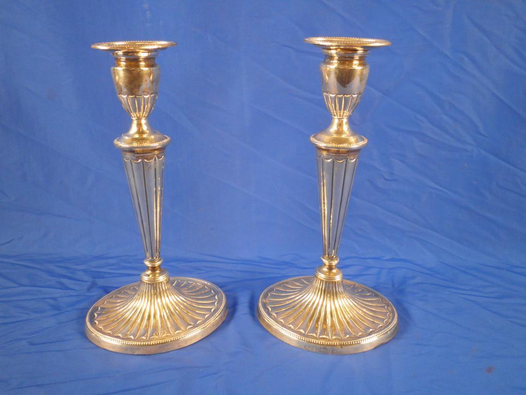 Appraisal: A pair of silver candlesticks each of tapering form on