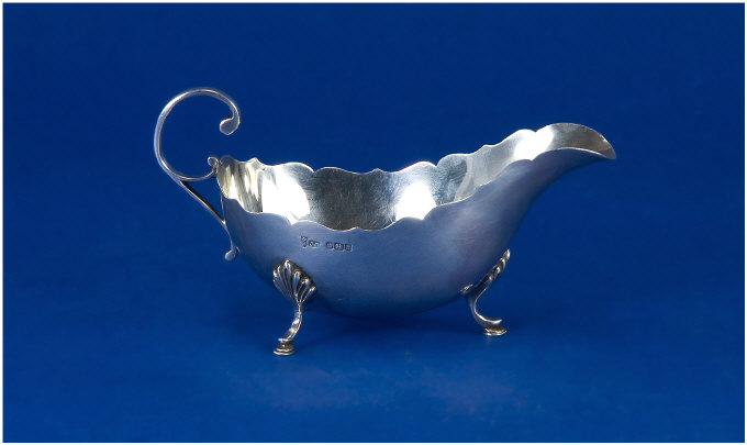 Appraisal: Edwardian Silver Sauce Boat With scroll handle on three feet