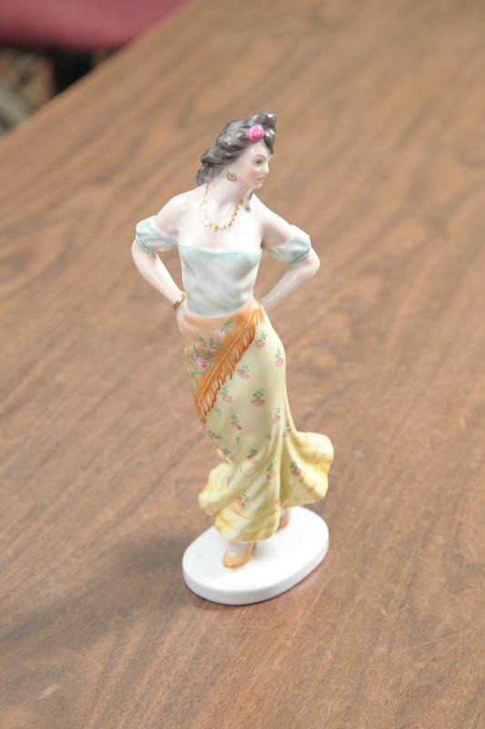 Appraisal: HEREND FIGURINE A woman in yellow dress and blue blouse