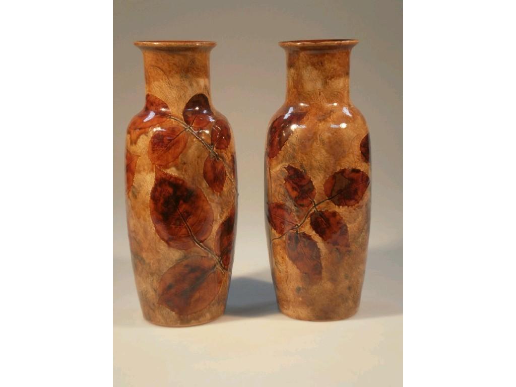 Appraisal: A pair of Royal Doulton stoneware foliage ware vases of