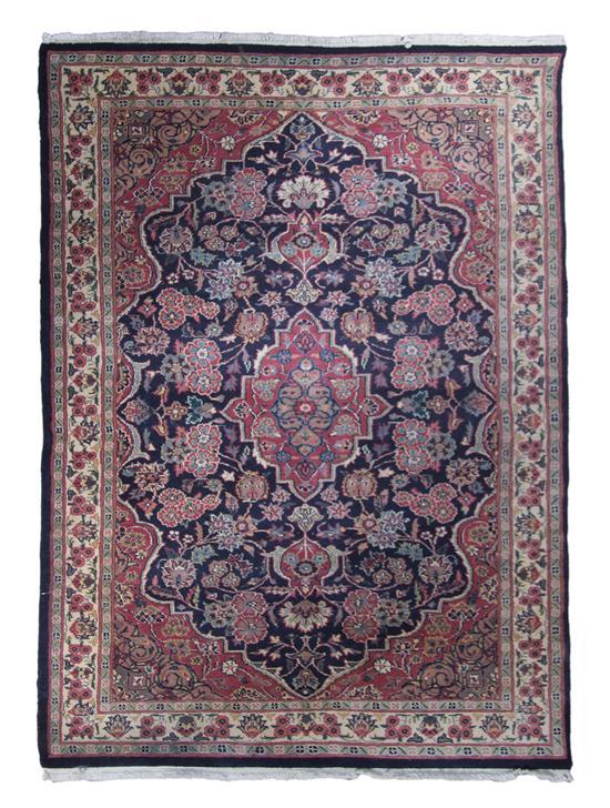 Appraisal: Kashan Wool Rug having a foliate center medallion on a