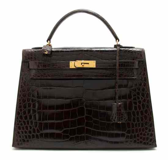 Appraisal: An Hermes Brown Crocodile Kelly Bag with a matching strap