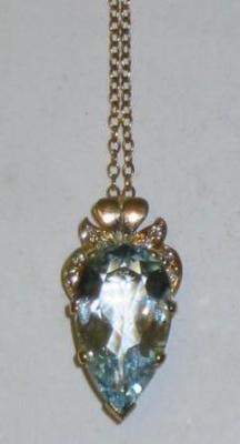 Appraisal: AN AQUAMARINE PENDANT the pear cut aqua claw set beneath