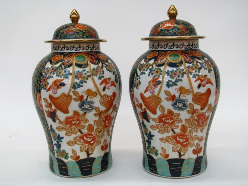 Appraisal: A pair of lidded porcelain Oriental jars paneled with scenic