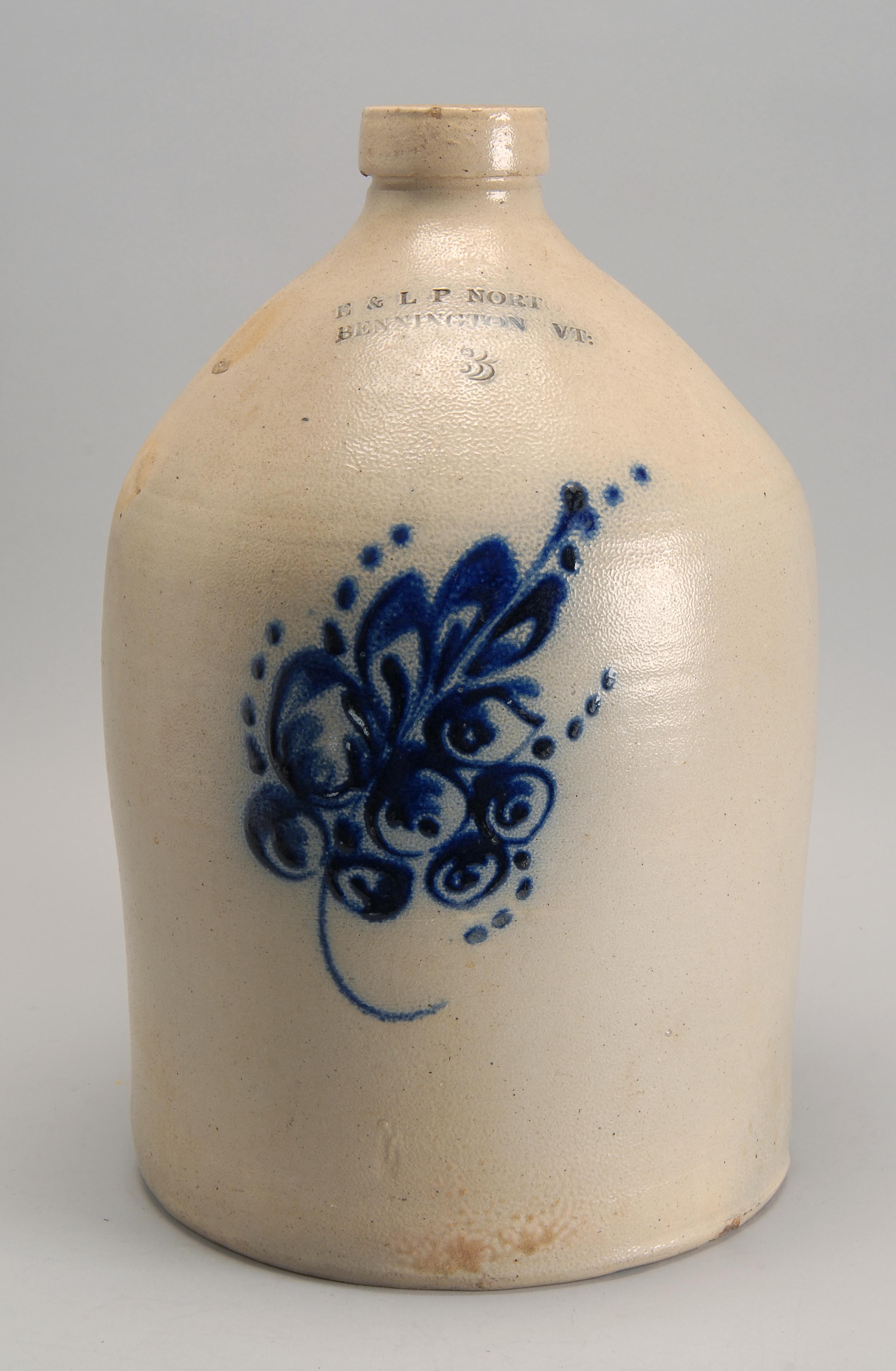 Appraisal: TH CENTURY AMERICAN STONEWARE THREE-GALLON JUG with cobalt blue foliate