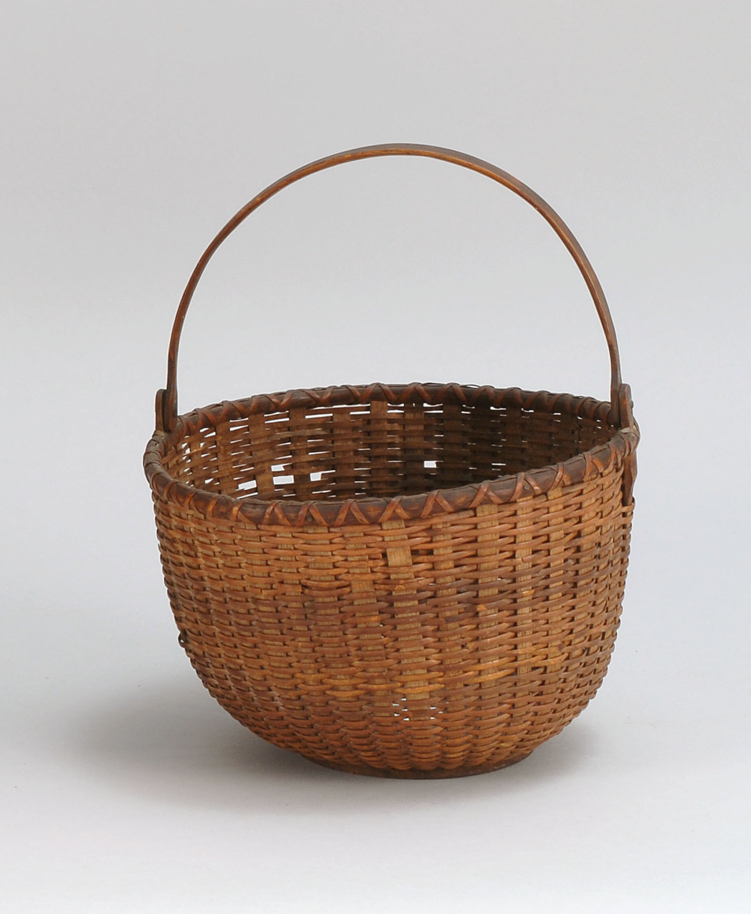 Appraisal: SWING-HANDLED NANTUCKET BASKET Late th CenturySplintwork sides and turned wooden