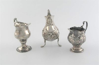 Appraisal: Three baluster cream jugs a George III example with punch