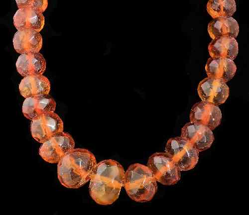 Appraisal: An mm single strand of orange amber faceted beads gross