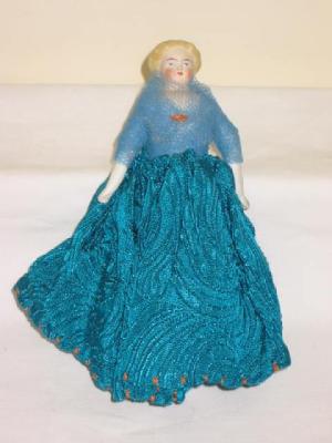 Appraisal: A bisque shoulder head pin cushion doll with painted and