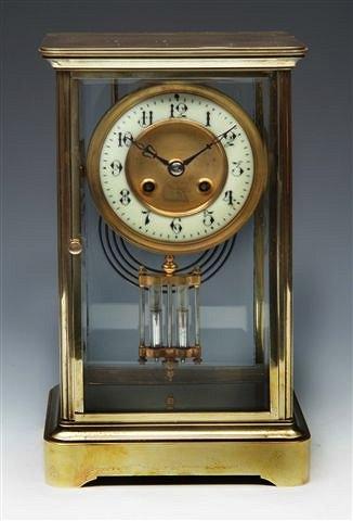 Appraisal: A FRENCH BRASS CASED FOUR GLASS MANTEL CLOCK with enamel