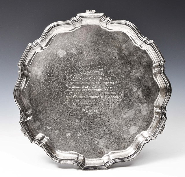 Appraisal: A SILVER SALVER with a Chippendale style border standing on