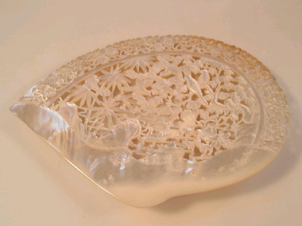 Appraisal: A mother-of-pearl shell pierced and carved with birds flowers bamboo