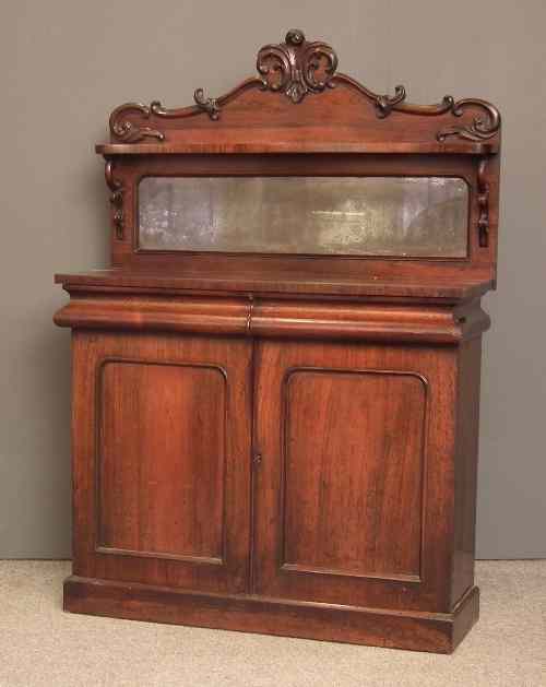 Appraisal: A Victorian rosewood chiffonier with shaped low back fitted one