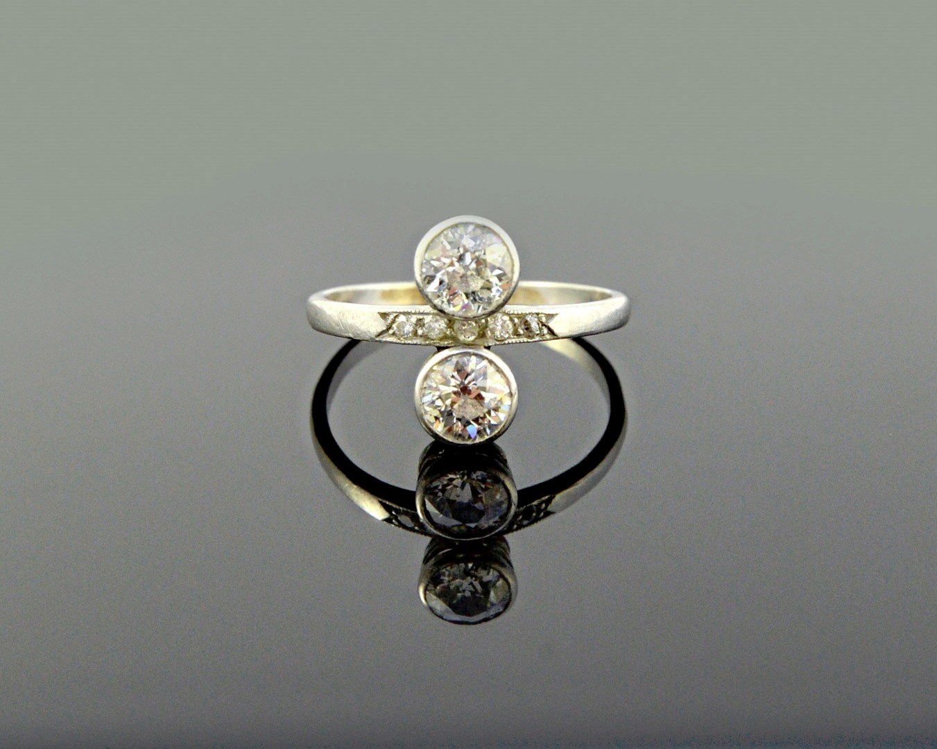 Appraisal: A diamond ring collet set with the two principal cushion