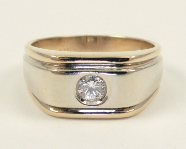 Appraisal: MAN'S DIAMOND AND FOURTEEN KARAT GOLD RING centering a round