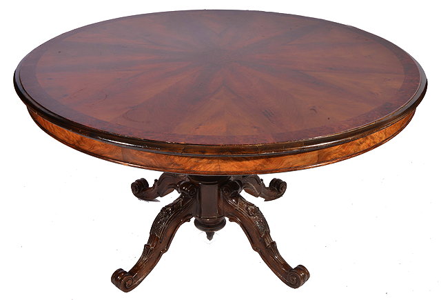 Appraisal: A CIRCULAR WALNUT DINING TABLE with quartered veneered top with