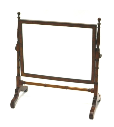 Appraisal: An early thC mahogany framed swing mirror on scroll feet