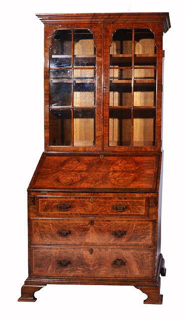 Appraisal: A BARTHOLOMEW AND FLETCHER WALNUT VANEERED BUREAU BOOKCASE with two