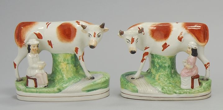 Appraisal: PAIR OF STAFFORDSHIRE FIGURES OF COWS Circa Rust-red and white