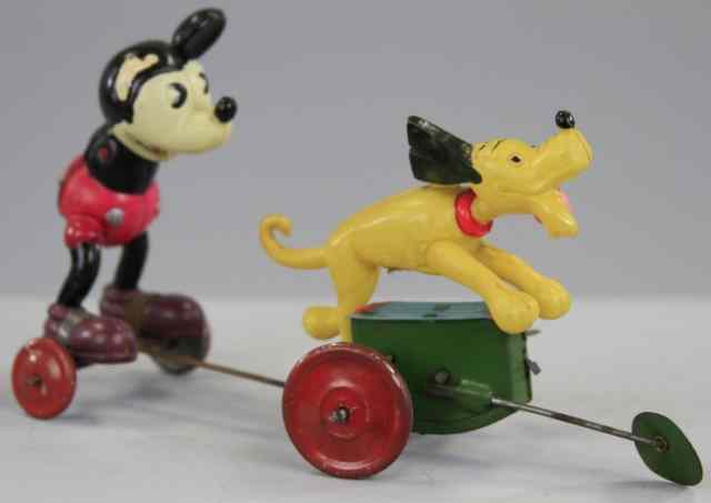 Appraisal: MICKEY PULLED BY PLUTO Japan celluloid figure of Mickey in