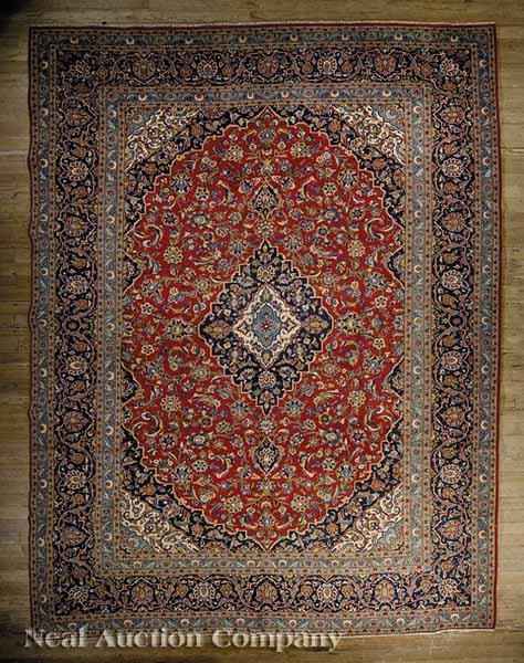 Appraisal: A Keshan Carpet red and blue ground central medallion and