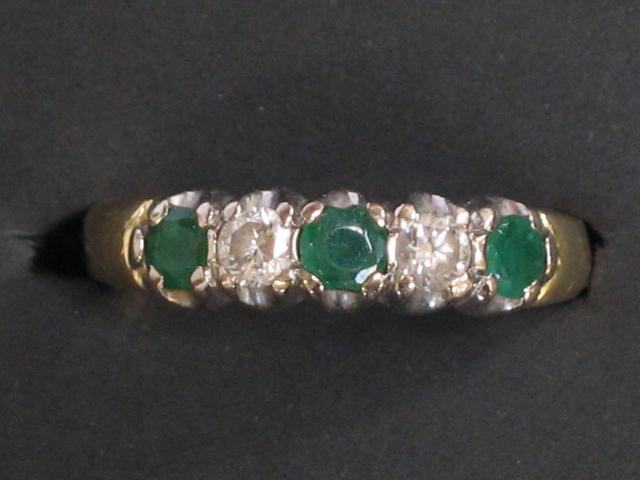 Appraisal: A FIVE STONE EMERALD AND DIAMOND DRESS RING the three