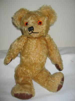 Appraisal: A Merrythought teddy bear covered in gold plush with amber