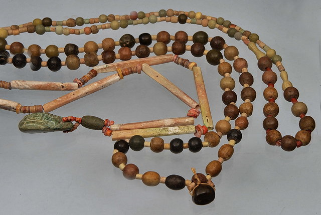 Appraisal: A SOUTH AMERICAN BEAD NECKLACE AND PENDANT elongated fossilized shell