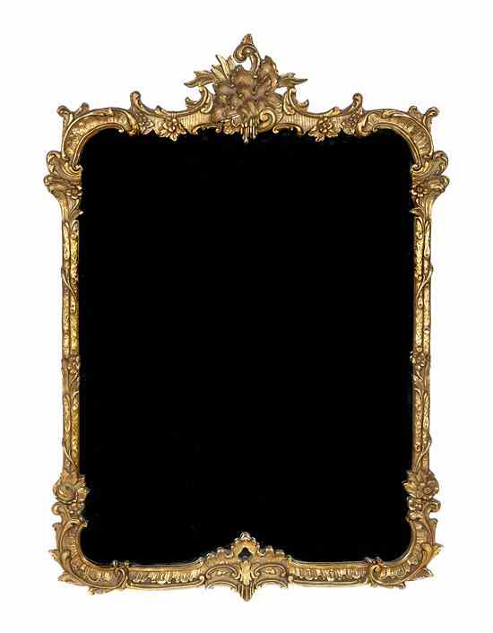 Appraisal: An Italian Giltwood Mirror having a shaped rectangular plate within