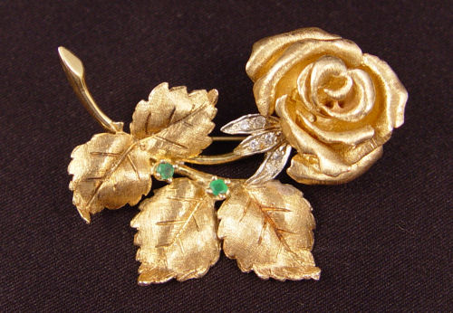 Appraisal: K ROSE BROOCH ACCENTED WITH EMERALDS DIAMONDS K yellow gold