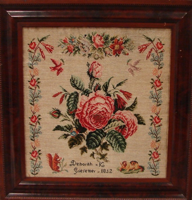 Appraisal: Needlework wool central floral medallion surrounded by two doves squirrel