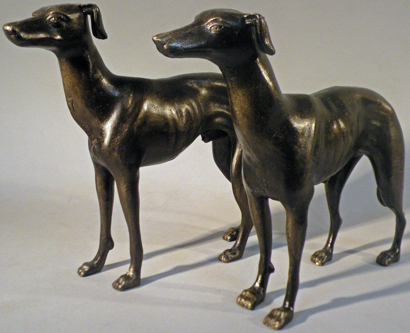 Appraisal: A pair of cast greyhound figures cm high