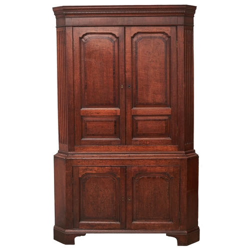 Appraisal: A George III oak and crossbanded standing corner cupboard of