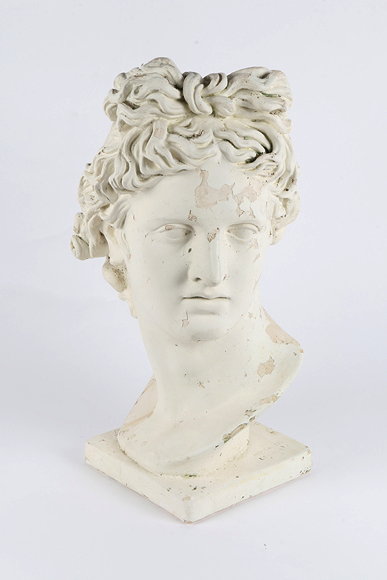 Appraisal: A DECORATIVE PLASTER BUST OF APOLLO approximately cm tall