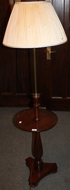 Appraisal: A MAHOGANY STANDARD LAMP with brass column