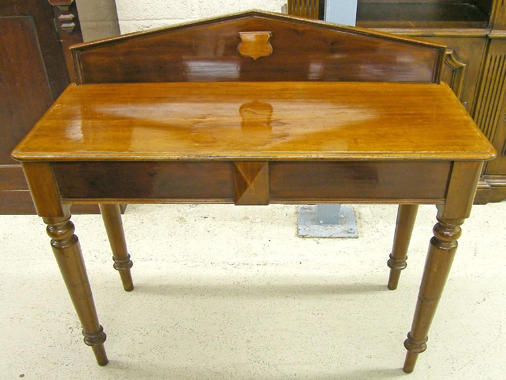 Appraisal: Victorian mahogany hall table the triangular raised back over a