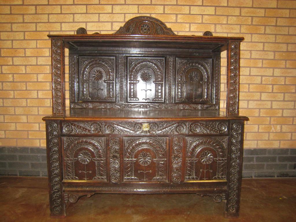 Appraisal: An antique oak Buffet raised shelf with carved panelled back