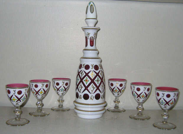 Appraisal: BOHEMIAN OVERLAY GLASS LIQUOR SET White glass cut to cranberry