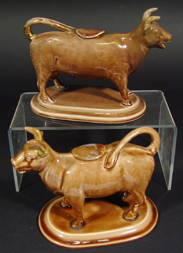 Appraisal: Two th Century Staffordshire cow creamers and lids each decorated