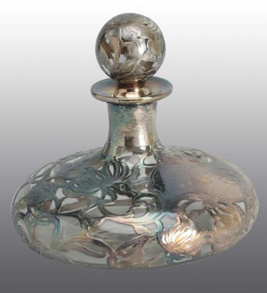 Appraisal: Heavy Silver Overlay Perfume Bottle Description Floral design with lid