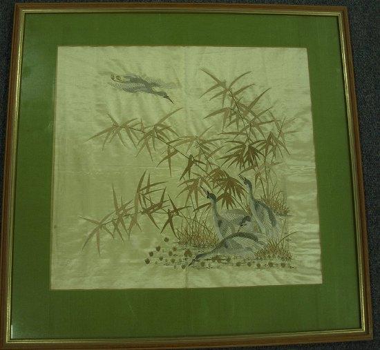 Appraisal: A Japanese embroidered silk panel decorated cranes among rushes cm